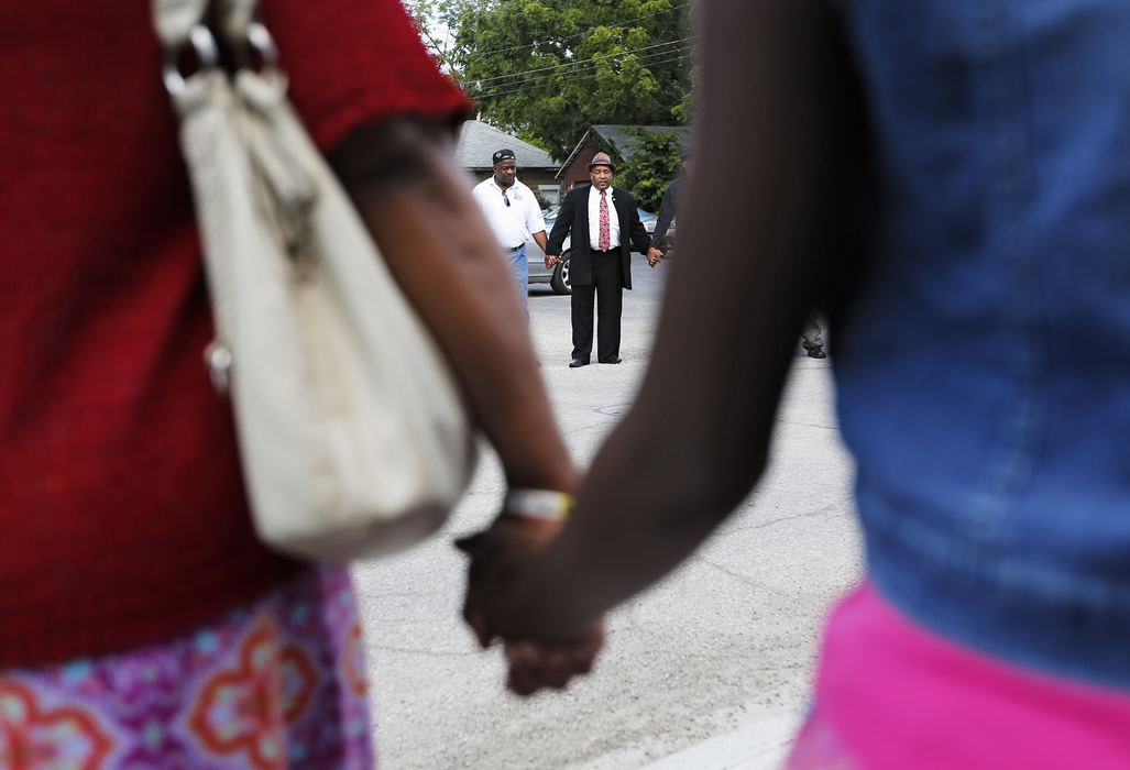 Second Place, James R. Gordon Ohio Undertanding Award - Eamon Queeney / The Columbus DispatchOutreach minister Aaron Hopkins says a prayer before the 46th South Side March, Sunday afternoon, August 4, 2013. On the first Sunday of every month the community around the Family Missionary Baptist Church on the South Side stages a march against violence. An 42-block area on the South Side plagued with shootings and nicknamed Soufganistan by the youth there went almost 2 years with no deaths until this summer. 