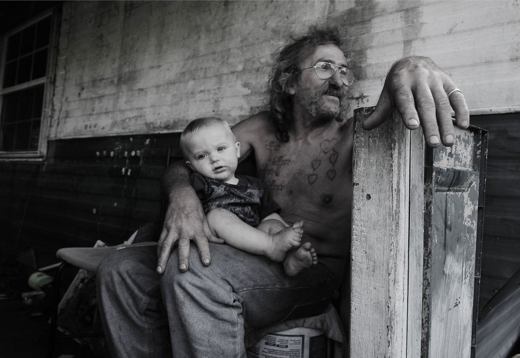First Place, James R. Gordon Ohio Undertanding Award - Jacob Byk / Kent State UniversityRoy “Buckey” Baker relaxes on his porch with his grandson, Blake, on a warm August day. Baker lives closest to the large mountain of mine waste that can be seen for miles outside of Nemacolin.