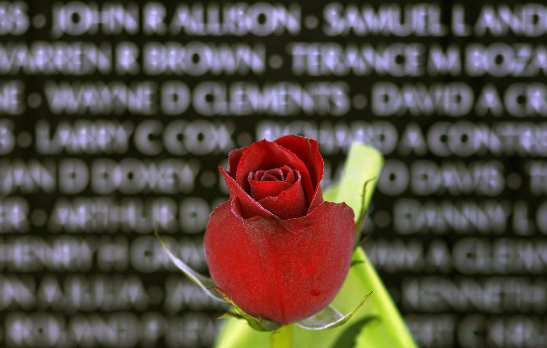 Third Place, Pictorial - Ernest Coleman / FreelanceA rose sits in front of the American Veterans Traveling Vietnam wall in Union Township with the names of Veterans who lost there live during the Vietnam war on the traveling wall.  The American Veterans Traveling Tribute is a group of veteran owners who are committed to travel the USA to honor, respect, and remember those who served, and pay specific tribute to those who gave all.