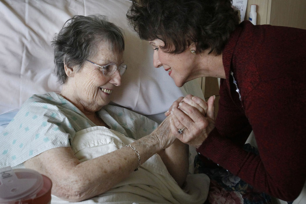 First Place, Photographer of the Year - Large Market - Katie Rausch / The (Toledo) Blade "Each room you go into you enter into another story," Joyce Rimmelin, right, said. Rimmelin embraced Claire Campbell, 82, on her volunteer rounds at ProMedica's Ebeid Hospice Residence in Sylvania. Rimmelin has been a believer in hospice care for many years. After the death of her husband in hospice at Ebeid House, Rimmelin decided to continue visiting and volunteering with staff and patients. "For that brief period of time, with not having any family of my own, they become my family," she said. "The best days of my week are the days that i am present in-patient unit." 