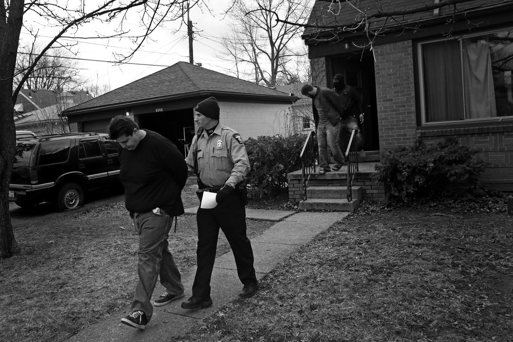 First Place, Photographer of the Year - Large Market - Katie Rausch / The (Toledo) BladeAdam Michilak, left, and Joshua Bennett, right, are led out a South Toledo home by police after Toledo Narcotics and SWAT officers raided the house at 3034 S. Byrne Road on April, 12. Police valued the confiscated materials, including up to 65 hydroponic marijuana plants, seven pounds of processed marijuana, and an SKS assault rife, and a Dodge Charger at an estimated $115,800. Much of the marijuana seized was hydroponically grown, a shift officials say has been impacted by the higher potency marijuana commonly used by medicinal marijuana users in Michigan. 
