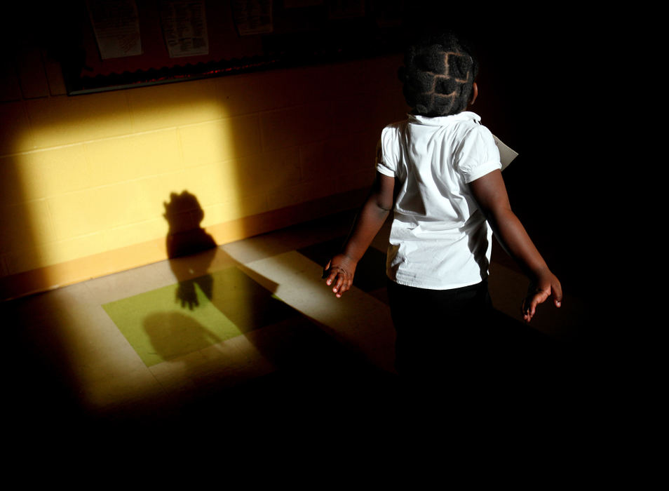 Second Place, Photographer of the Year - Large Market - Lisa DeJong / The Plain DealerA student floats through a patch of sunlight, discovering the artful shapes her hands can make in her shadow. Finding art in everyday happenings is essential to the curriculum at Euclid Park Elementary. Some of Cleveland's elementary schools have fought to keep their art classes strong. 