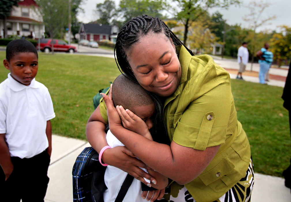 Second Place, Photographer of the Year - Large Market - Lisa DeJong / The Plain DealerReading Intervention teacher Shondra Shine, right, hugs an upset first grader Tywann Talley, 5, on the very first day of school at Anton Grdina Elementary School (cq) in Cleveland.  Teachers met the students outside as they arrived at school at around 7:30 a.m. Shine, who has been a teacher for two decades, says she loves to hug away the tears on their scary first day of school. 