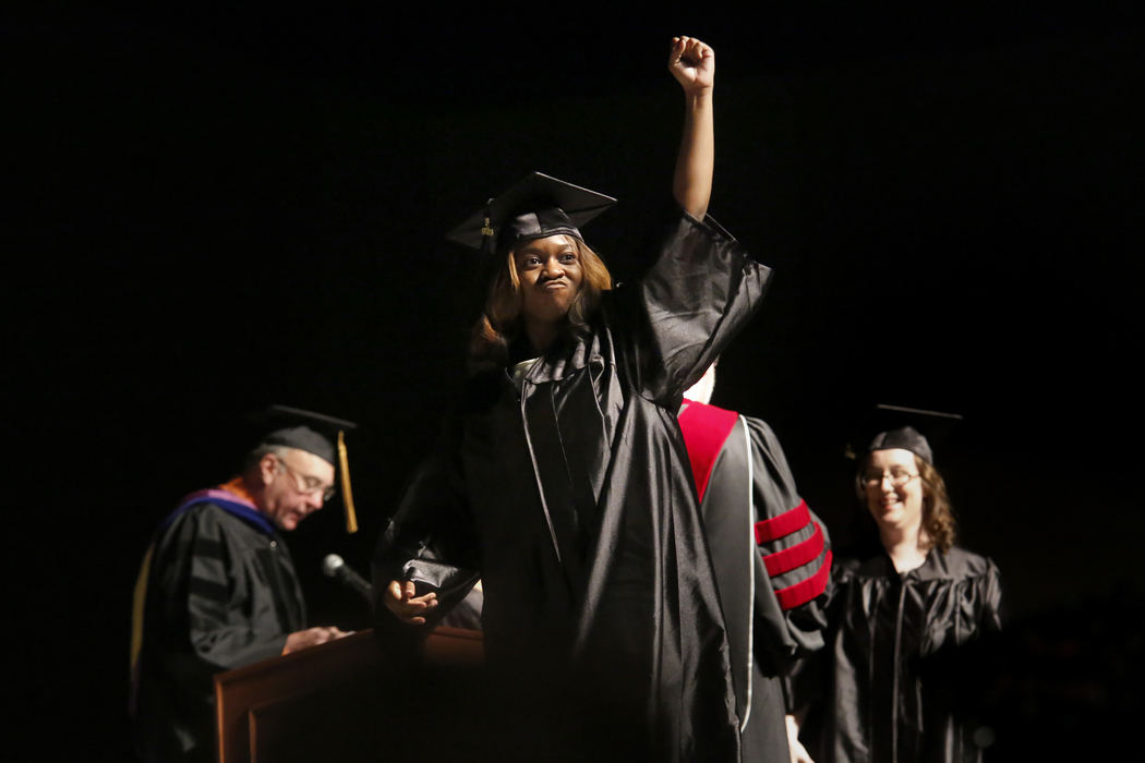 First Place, Photographer of the Year - Large Market - Katie Rausch / The (Toledo) BladeBianca Bryant, of North Toledo, center, raised her fist in the air as she received her bachelors in psychology during the Lourdes University 55th Commencement Saturday, May 18, 2013 at the SeaGate Convention Centre in downtown Toledo. Hundreds of people turned out to celebrate the commencement of students with graduating with everything from associate to bachelor to master to honorary doctoral degrees.  