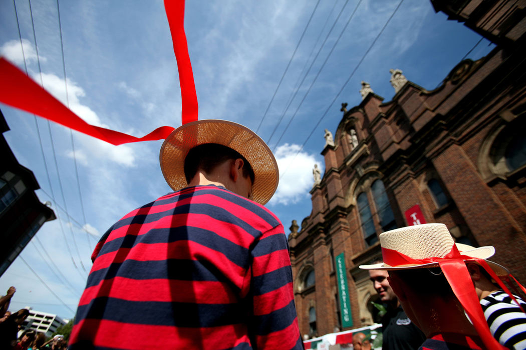 Second Place, Photographer of the Year - Large Market -  Lisa DeJong / The Plain DealerA breeze blows through the ribbons of the traditional Italian hat worn by Richard Trivisonno, 11, as he waits outside of the Holy Rosary Church in Little Italy for the start of the 115th Feast of The Assumption procession. About 100,000 people descend onto the Little Italy neighborhood to celebrate the Virgin Mary being taken to heaven. The four-day celebration is packed with food, music and bocci ball. 