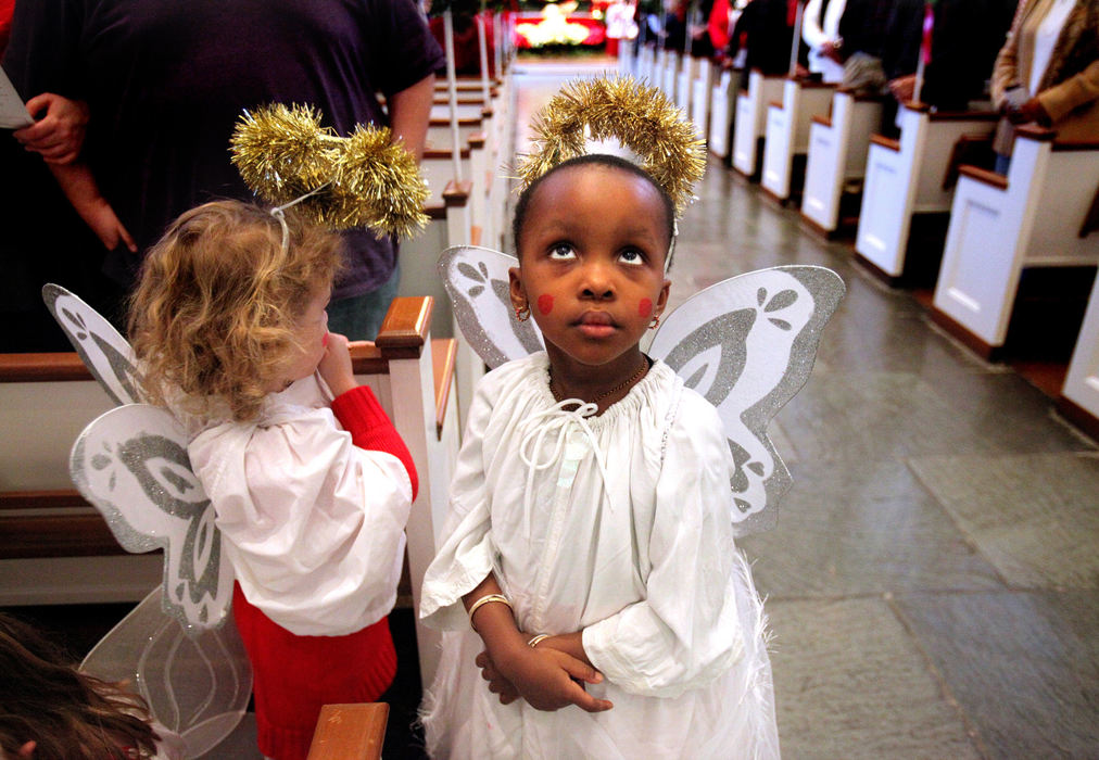 Second Place, Photographer of the Year - Large Market - Lisa DeJong / The Plain DealerMargareta Okafor, 3, (cq!) looks up to the balcony where the a narrator speaks as she and other angels wait to flap their wings down the aisle to the front of the church during The Christmas Pageant at Christ Episcopal Church in Shaker Heights. This is the 20th year for the pageant on Christmas eve that tells the story of Joesph, Mary and baby Jesus. The pageant also had live animals including a donkey, a camel, goats and one yak. 