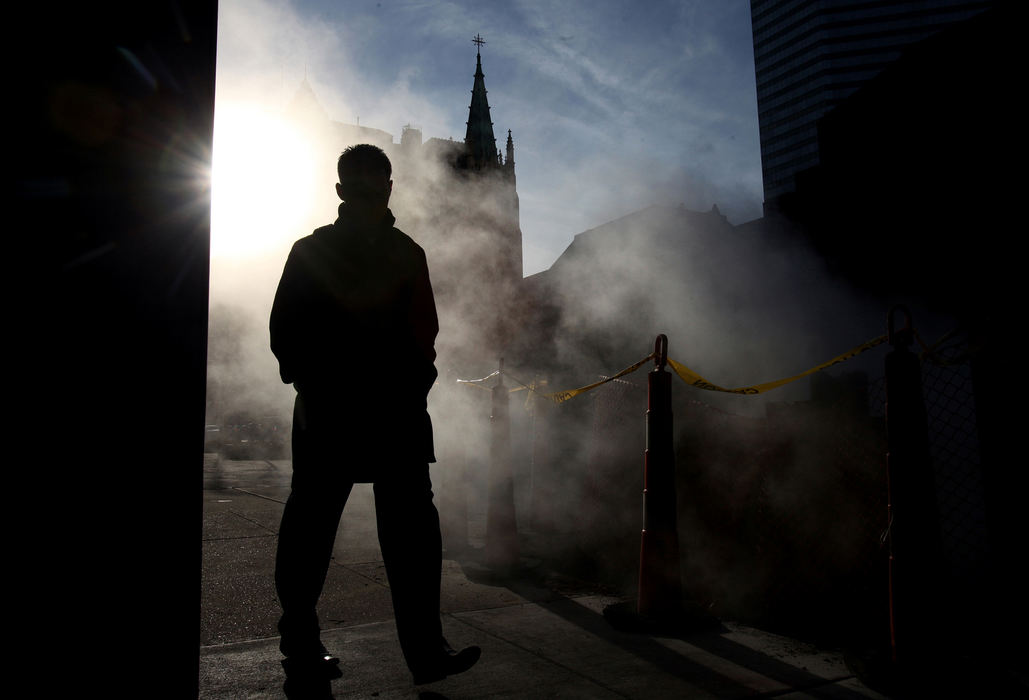 Second Place, Photographer of the Year - Large Market - Lisa DeJong / The Plain DealerA man walks eastward on Superior Avenue near E. 12th Street in downtown Cleveland as the sun shines through steam coming up from a construction site on the sidewalk. Construction along Superior is coming is finally coming to an end. 