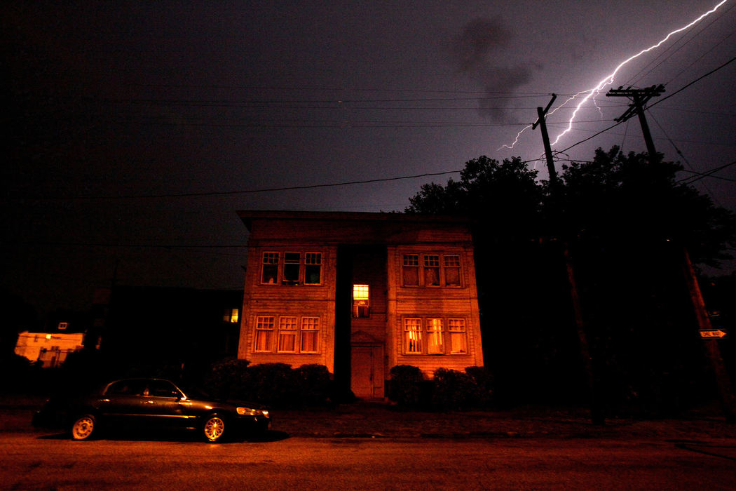 Second Place, Photographer of the Year - Large Market - Lisa DeJong / The Plain DealerReinvestigating Rape (Synopsis): They stalked Cleveland’s East Side 20 years ago, ambushed women or girls as they walked along city streets, dragged them into the backyards of blighted houses, into wooded areas and garbage-strewn lots, and raped them. The serial rapists were never caught. But they left behind their DNA. Collected from each victim at local hospitals as part of a “rape kit”, the DNA remained untested alongside hundreds of others that would wait nearly two decades to tell their secrets. The Cleveland Police Department's dismissive approach was to shelve and forget thousands of rape kits that contained DNA evidence collected from survivors. The callous indifference of the Cleveland Police Department enabled a rape culture to flourish. Cuyahoga County investigators are now revisiting decades-old unsolved rape cases, using DNA evidence to connect serial rapes and sending cases to grand juries for indictment - often racing against a 20-year statute of limitations. The following images are where attackers ruthlessly raped their victims 20 years ago.  Each caption reveals the name of the rapist, each one now indicted on the rape that happened near where the image was made. Many of the locations were just steps away from busy streets, schools and heavily populated but deteriorating urban neighborhoods. Some of the serial rapists walked free for two decades. Until now. More than 75 have been indicted in Cuyahoga County, some with only a few days left within the 20-year statute of limitations. CAPTION for this FIRST IMAGE:  More than two decades after Cynthia Espey told police she was attacked by serial rapist Michael Bass at knifepoint in this apartment building, her nightmare has ended. Police never tested her rape kit. The case was reopened this year after DNA evidence revealed that Bass had lied to police in a 1993 statement. Prosecutors indicted the case just TWO days before the 20-year statute of limitations on the rape case ran out.