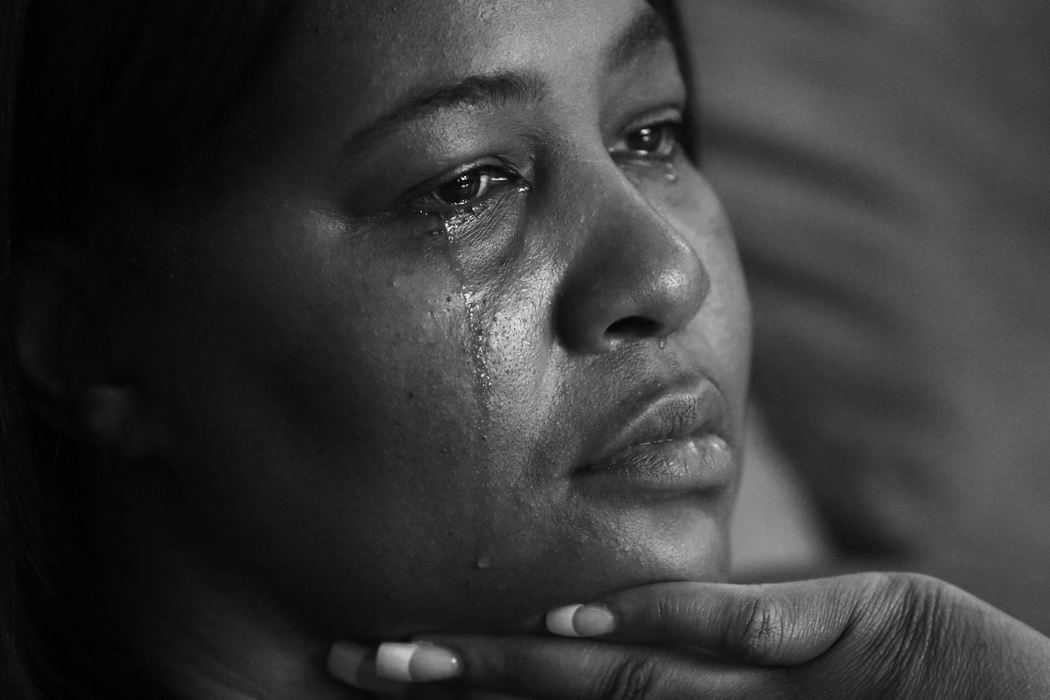 First Place, Photographer of the Year - Large Market - Katie Rausch / The (Toledo) BladeCosma Miller, of South Toledo, cries as she shares memories of her friend Wendabi Triplett, who was gunned down in December of 2012. Triplett's estranged husband, Robert Carter, is charged with aggravated murder. Triplett was murdered in front of her three children outside the house of a friend.   