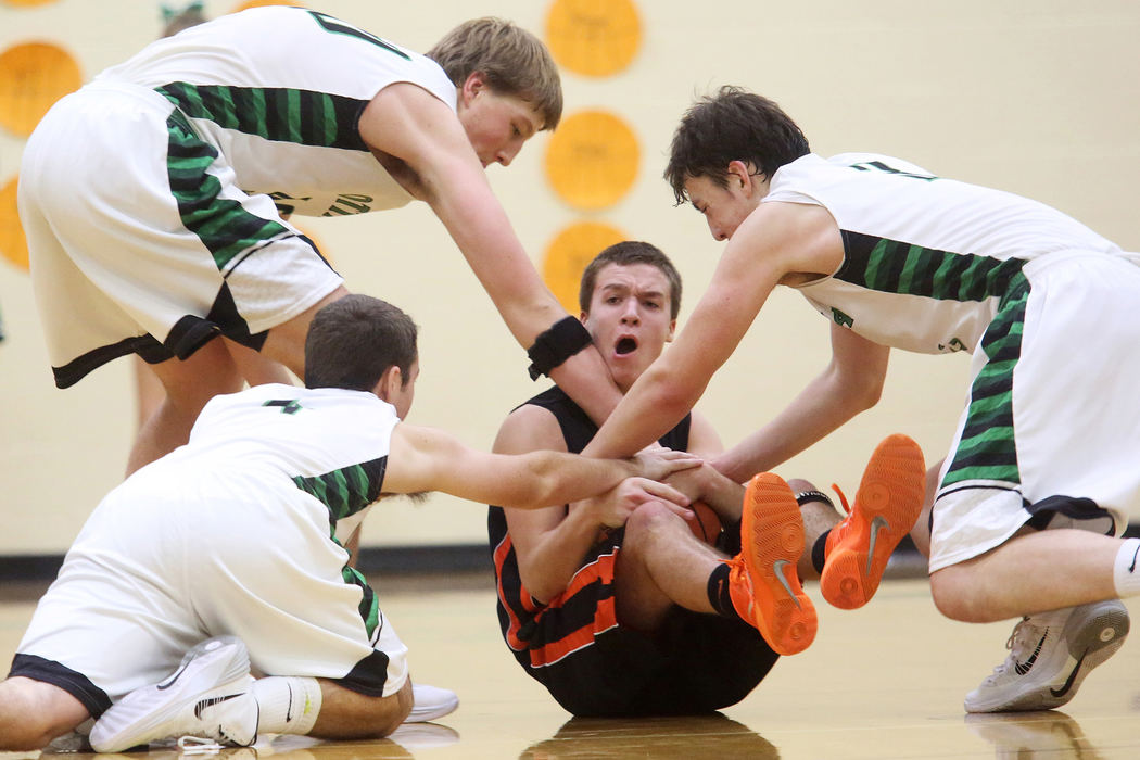 First Place, Photographer of the Year - Large Market - Katie Rausch / The (Toledo) BladeGibsonburg's junior Jordan Kreglow, center, attempts to keep a hold of the ball under pressure from Ottawa Hills during the fourth quarter of the Friday, Dec. 13, 2013, match up at Ottawa Hills. Ottawa Hills overcame Gibsonburg to win, 47-39. 