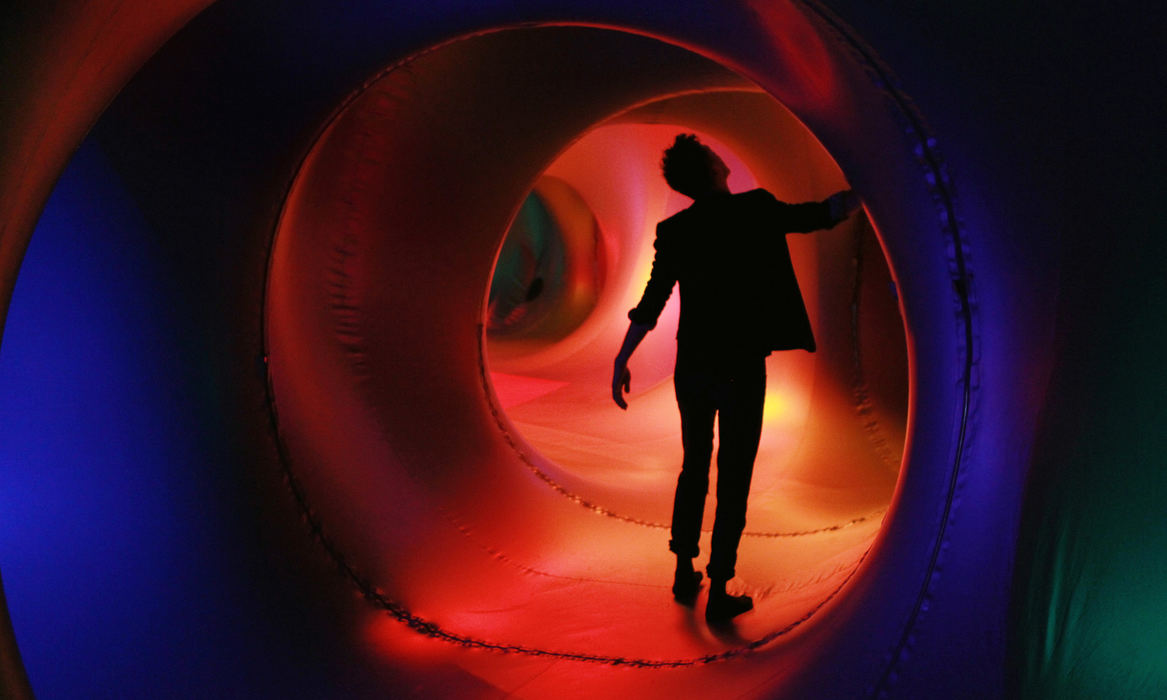 , Photographer of the Year - Large Market - Gus Chan / The Plain DealerDavid King walks through a luminarium called Exxopolis in the parking lot across from Playhouse Square Wednesday, May 8, 2013.  Exxopolis is an inflatable sculpture that changes depending on the daylight.  Exxopolis is part of the International Children's Festival, which takes place May 9th through May 11th  King is part of ZooZoo, a theatre troop that will also perform at the festival. 