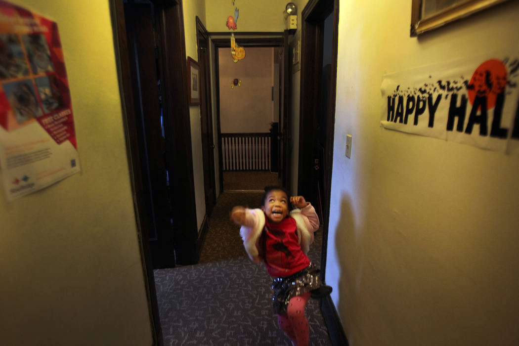 , Photographer of the Year - Large Market - Gus Chan / The Plain DealerSienna Blue, 5, jumps as she tries to bat at a Halloween decoration in the halls of Broadway School of Music.  Blue is one of five homeschooled children in her family that take music lessons at Broadway School.  She is the fifth child. 