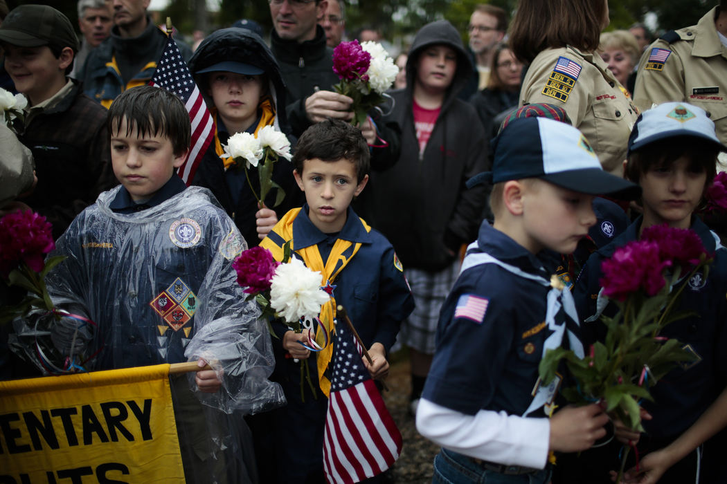 First Place, Photographer of the Year - Small Market - Joshua A. Bickel / ThisWeek Community NewsZac Heyob, 7, center waits with Ben Moffitt, 9, left, and Ganen Roach, 9, second from left along with the rest of Cub Scout Pack 679 while waiting to place flowers at the base of an American Flag during a dedication ceremony for the new Killed in Action memorial as part of Memorial Day ceremonies May 27, 2013 in Dublin, Ohio.