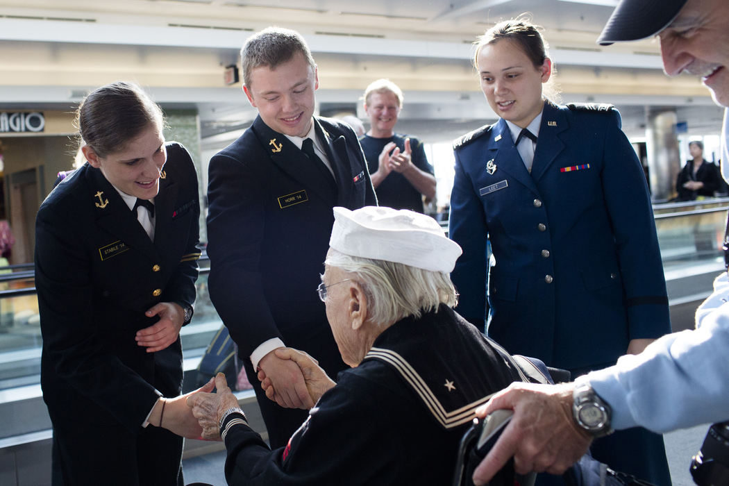 First Place, Photographer of the Year - Small Market - Joshua A. Bickel / ThisWeek Community NewsNavy Midshipman 2nd Class Julie Stabile, left, of Framingham, Mass., and Navy Midshipman 2nd Class Cody Horr, center, of Houston, greet World War II Navy veteran Ralph Heller, of Columbus, after his Honor Flight landed Apr. 27, 2013 at Baltimore-Washington International Airport.
