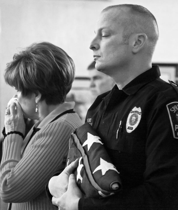 Second Place, Photographer of the Year - Small Market - Barbara J. Perenic / Springfield News-SunOfficer Michael Fredendall closes his eyes after receiving a folded American Flag during a memorial service for his fallen K-9 partner Rambo, who passed away after battling cancer. 