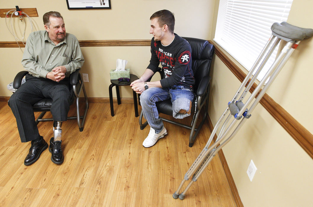 Second Place, Photographer of the Year - Small Market - Barbara J. Perenic / Springfield News-SunEarl Isaacs of Waynesville counsels Trevor Bates of Greenville at Optimus Prosthetics in Dayton. Both are artists, both had amputations of their left legs due to motor vehicle accidents. Isaacs wears the advanced BiOM bionic foot and ankle prosthesis while Bates has not yet been able to fit comfortably into a prosthesis.