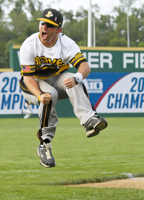 Second Place, Photographer of the Year - Small Market - Barbara J. Perenic / Springfield News-SunShawnee head coach Andy DeWitt celebrates with a flying leap into the air at third base after Joey Chapman hit a two-run homer to bring the Braves within a run of tying Jonathan Alder during a Division II regional semifinal baseball game.