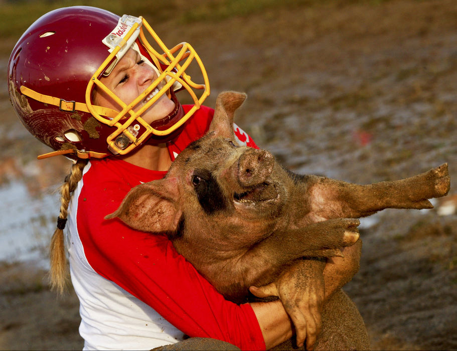 Second Place, Photographer of the Year - Small Market - Barbara J. Perenic / Springfield News-SunAmanda Raber of Northeastern High School wrestles with a squealing pig while competing in the annual pig scramble on the muddy track at the Clark County Fair on Friday evening.