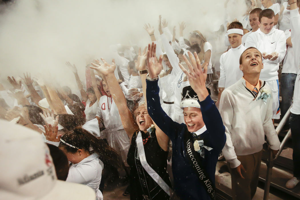 First Place, Photographer of the Year - Small Market - Joshua A. Bickel / ThisWeek Community NewsHilliard Darby Homecoming Queen Savannah Garrett, 17, and King Ryan Baldridge, 18, center, throw baby powder into the air as they cheer during kickoff of Darby's football game against Westerville South Oct. 11, 2013 at Hilliard Darby High School in Hilliard, Ohio.