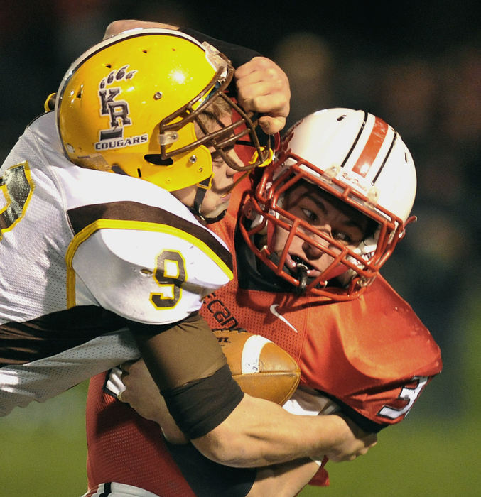 Third Place, Photographer of the year - Small Market - Bill Lackey / Springfield News-SunKenton Ridge's Justin Conley tackles Tippecanoe's Jacob Hall as he carries the ball during Friday's tournament game at Tipp.