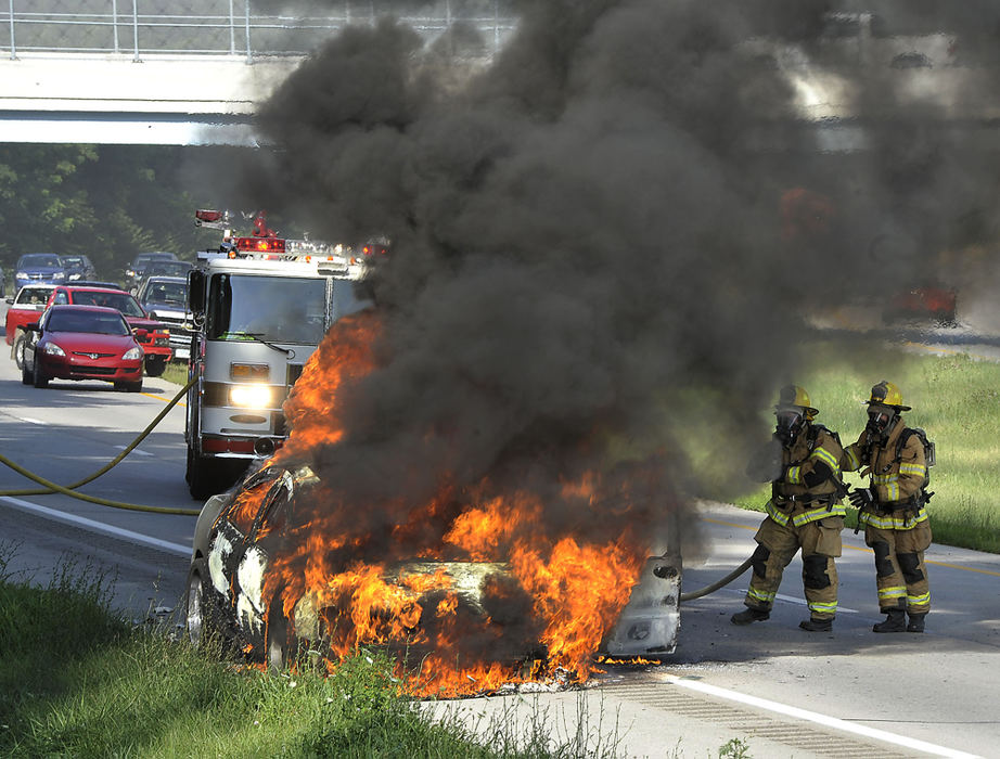 Third Place, Photographer of the year - Small Market - Bill Lackey / Springfield News-SunMembers of the Springfield Twp. Fire Division battle a fully engulfed car fire on State Route 4 near the Old Mill Road bridge that completely closed the southbound lanes of the the highway while the car was extenguished. There were no injuries in the fire. 