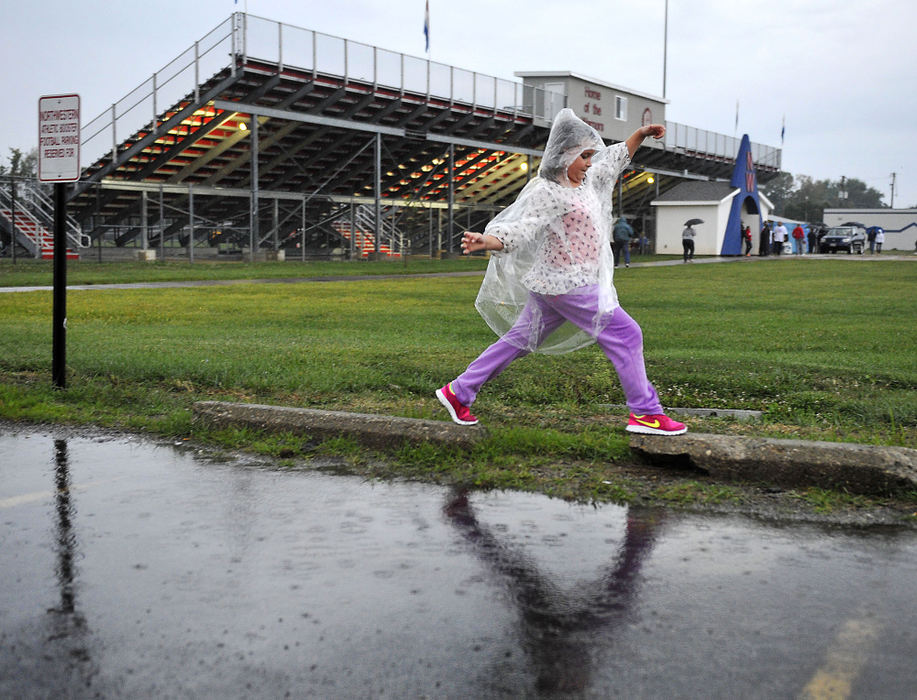 Third Place, Photographer of the year - Small Market - Bill Lackey / Springfield News-SunRianna Thorud, 8, makes her way across the rain puddles in the parking lot at Northwestern High School on her way back to her car Friday. The football game she had come to see between Northwestern and Shawnee High School had been canceled due to the weather.