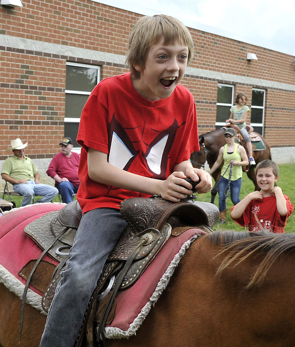 Third Place, Photographer of the year - Small Market - Bill Lackey / Springfield News-SunIsaiah Hill, 9, shows his excitement as he rides a horse for the first time. Hill and  his third grade classmates at Simon Kenton Elementary School got a chance to ride horses Thursday, May 23, 2013 as a reward for good behavior all school year. 