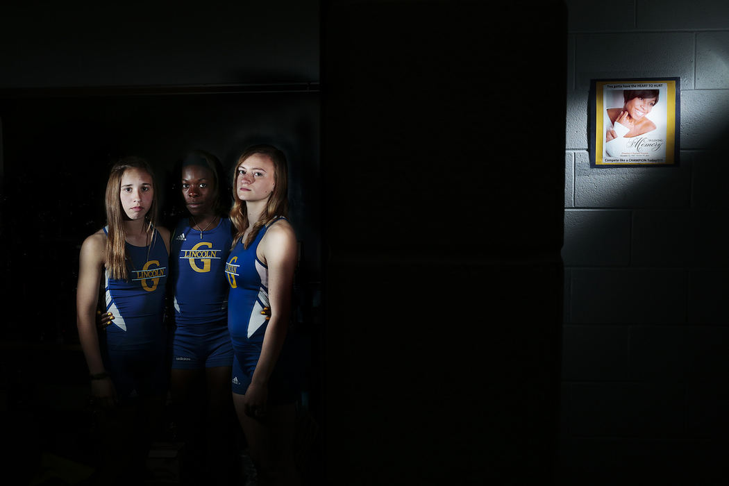 First Place, Photographer of the Year - Small Market - Joshua A. Bickel / ThisWeek Community NewsGahanna track athletes Sara Richards, Daniella Johnson and Sami Shaw pose for a portrait Apr. 25, 2013 at Gahanna Lincoln High School in Gahanna, Ohio. The three are returners on the relay team. Last October, the fourth member of the relay team, senior Dominae Gaston, was shot and killed. Now, the runners touch a picture of Dominae that hangs in the locker room before heading out to the track.
