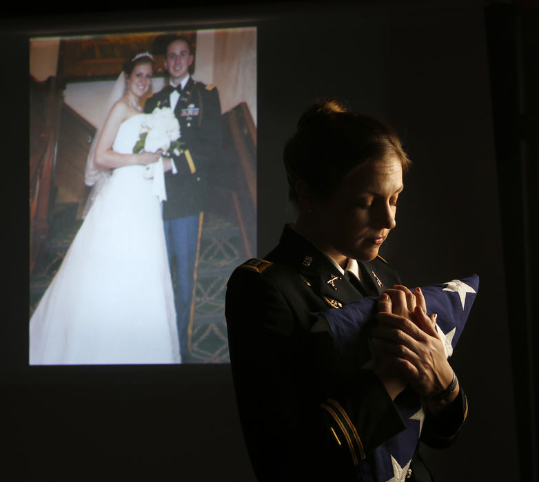 Third Place, Portrait Personality - Jonathan Quilter / The Columbus DispatchOhio State law student Jenna Grassbaugh holds the flag that draped her husband's coffin after he was killed in Iraq in 2007, 10 months after they were married. She is using the life insurance money to start a clinic to help returning veterans with legal and other services. 