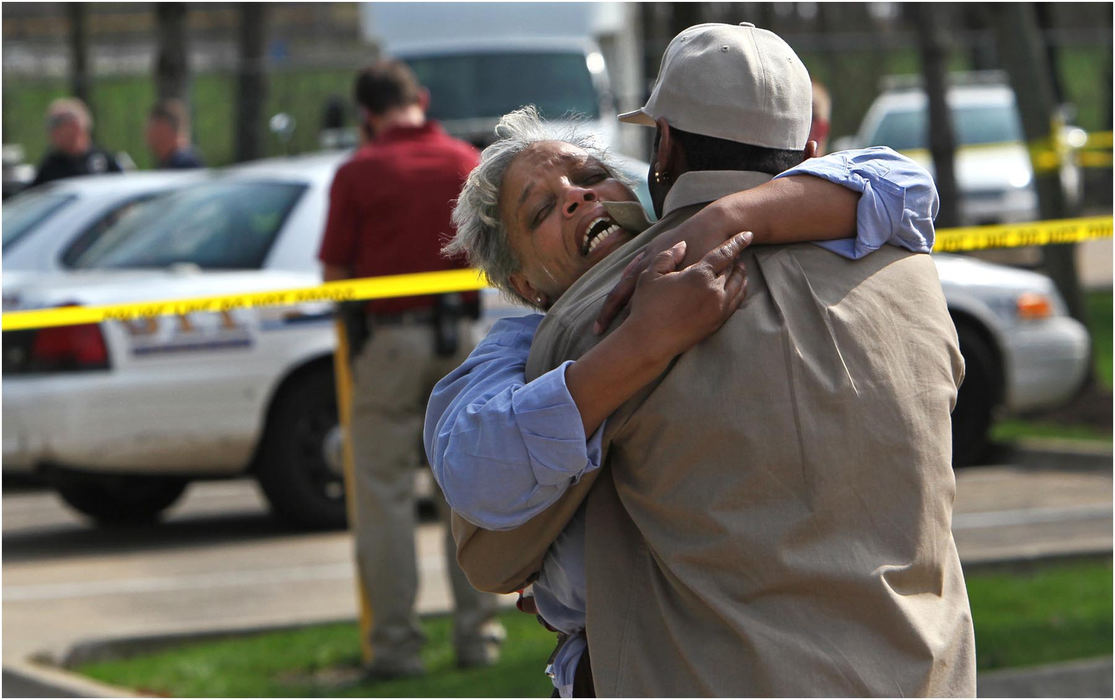 Second Place, Spot News - Large Market - Ed Suba Jr. / Akron Beacon JournalApril Roberts-Gilbert is comforted by her ex-husband, Donald Durham, after finding out that one of the four people found shot in the head in a basement of a housing complex was their son, Ronald Roberts.