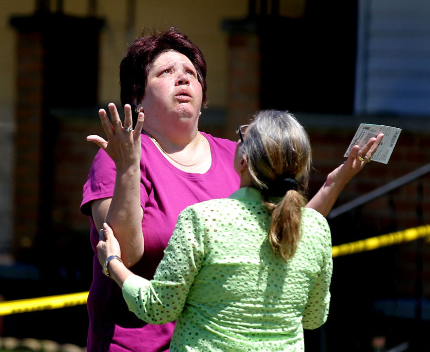 Award of Excellence, Spot News - Large Market - Lisa DeJong / The Plain DealerCharlene Milan (left) looks skyward as she sees her neighbor Nancy Ruiz, mother of Gina DeJesus, for the first time since Gina's arrival home yesterday. Nancy Ruiz's daughter Gina DeJesus came home yesterday after she was kidnapped and had gone missing for a decade. Three long-time missing women, Amanda Berry, Gina DeJesus and Michelle Knight, were found alive Monday, apparently kidnapped and held for years together as prisoners inside Ariel Castro's home on Cleveland's near West Side. 
