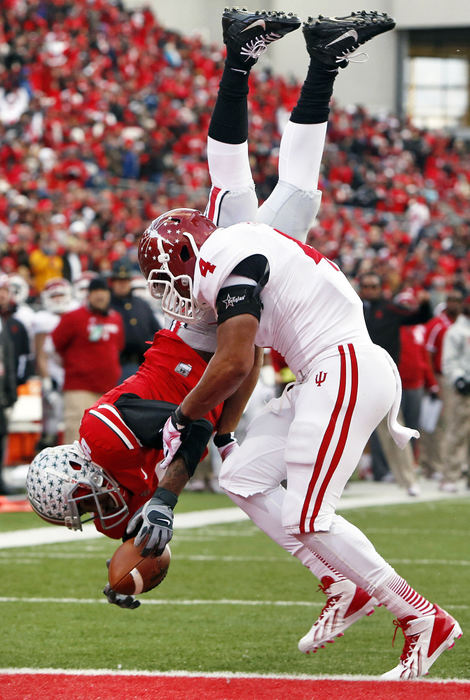 Award of Excellence, Sports Action - Barbara J. Perenic / The Columbus DispatchOhio State Buckeyes quarterback Braxton Miller (5) flips into the end zone for a touchdown as he is hit by Indiana Hoosiers linebacker Forisse Hardin (4) making the score 21-0 in the second quarter at Ohio Stadium in Columbus.