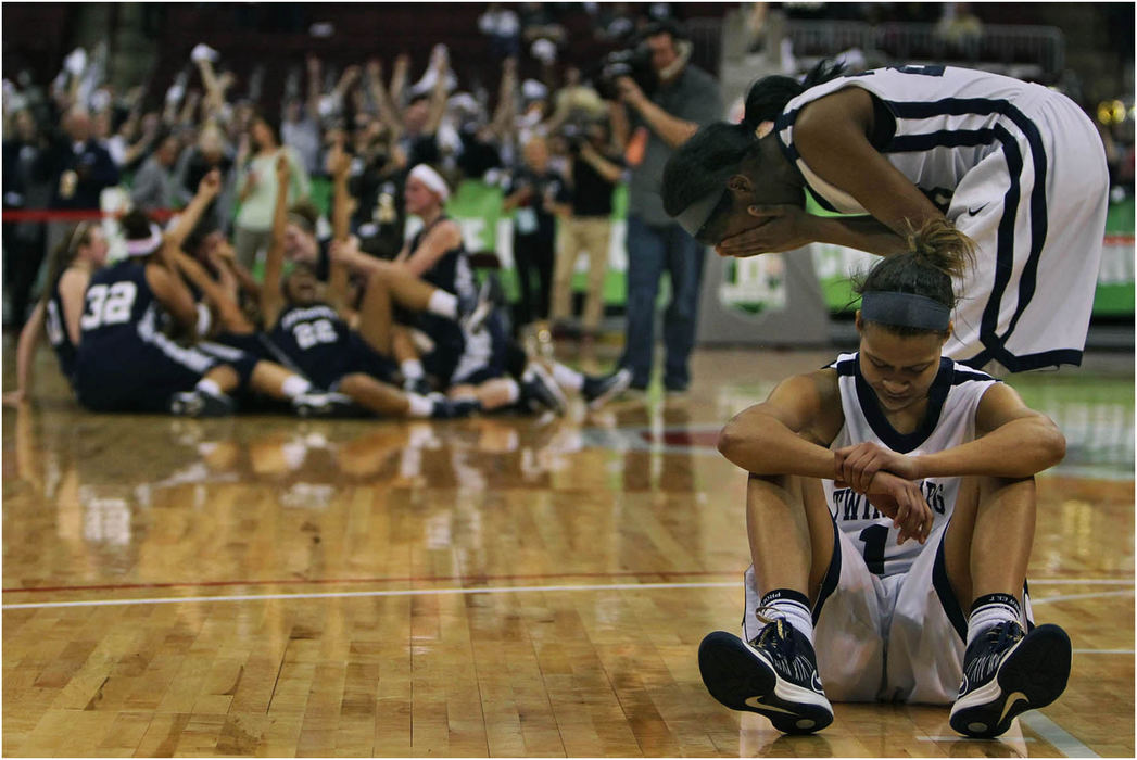 Second Place, Sports Feature - Ed Suba Jr. / Akron Beacon JournalDejected Twinsburg players Brooke Thompson-Smith and Ashlely Morrissette sit silently on the court as the Kettering Fairmont team celebrates after defeating the Tigers 52-48 in their Division I state final basketball game at Value City Arena in Columbus.