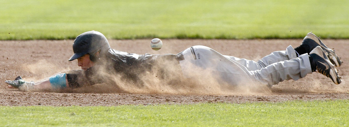 First Place, Ron Kuntz Sports Photographer of the Year - Joshua A. Bickel / ThisWeek Community NewsDublin Coffman's Jacob Gilbert beats the baseball as he slides toward second base during Coffman's game against Dublin Scioto during the Dublin Baseball Classic May 4, 2013 at Dublin Coffman High School in Dublin, Ohio.