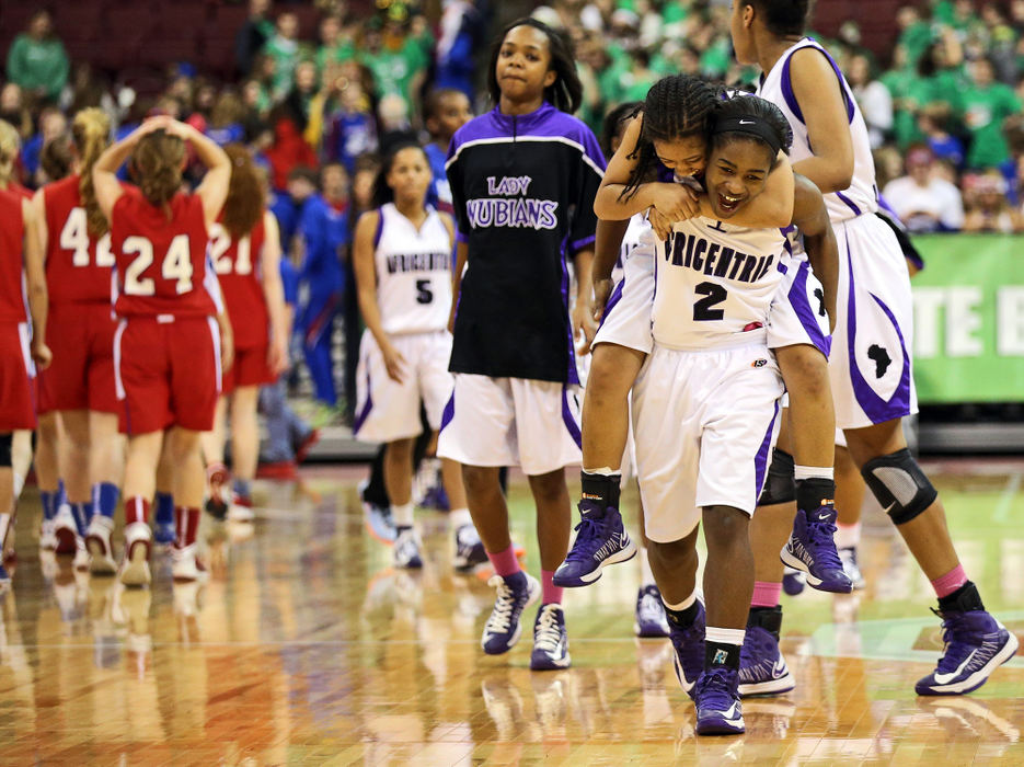 Second Place, Ron Kuntz Sports Photographer of the Year - Adam Cairns / The Columbus DispatchAfricentric guard Dayunna Johnson (11) jumps onto the back of teammate Kyra Jones (2) following the Nubians' 43-40 win over Beverly Fort Frye during the OHSAA Div. III girls basketball state semifinal game at Value City Arena in Columbus on March 14, 2013. 