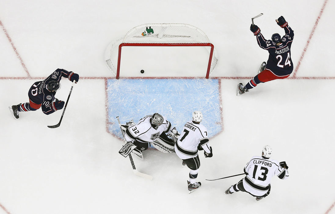 Second Place, Ron Kuntz Sports Photographer of the Year - Adam Cairns / The Columbus DispatchColumbus Blue Jackets center Derek MacKenzie (24) and center Mark Letestu (10) celebrate MacKenzie's goal past Los Angeles Kings goalie Jonathan Quick (32), defenseman Rob Scuderi (7) and left wing Kyle Clifford (13) during the first period of the NHL game at Nationwide Arena in Columbus, Ohio on Feb. 5, 2013. 