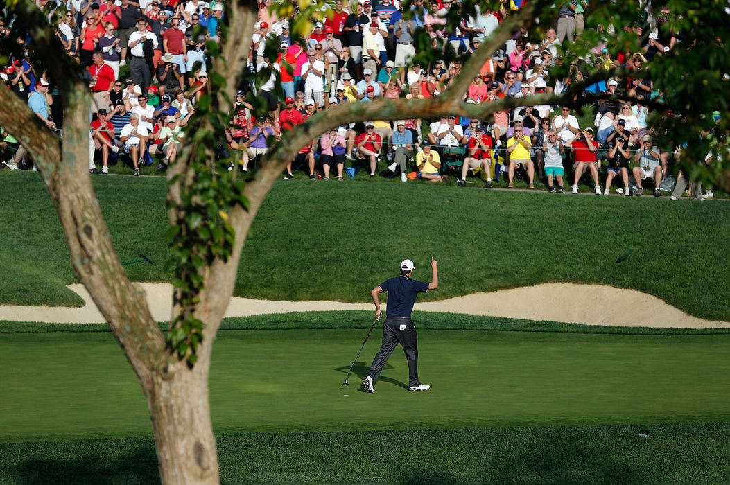 Second Place, Ron Kuntz Sports Photographer of the Year - Adam Cairns / The Columbus DispatchWebb Simpson of the United States Team thanks the crowd after hitting his putt on the 14th hole during the Presidents Cup at Muirfield Village Golf Club on Oct. 3, 2013. 