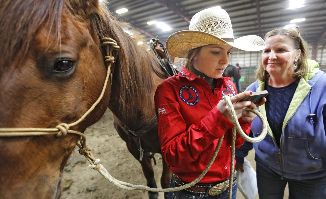 Award of Excellence, Ron Kuntz Sports Photographer of the Year - Chris Russell / The Columbus DispatchJosie Hume studies a video of her performance taken by her mother on her phone  during a late winter rodeo in Springfield, Ohio.  She was competing at the indoor event in preparation for the upcoming High School Rodeo season. 