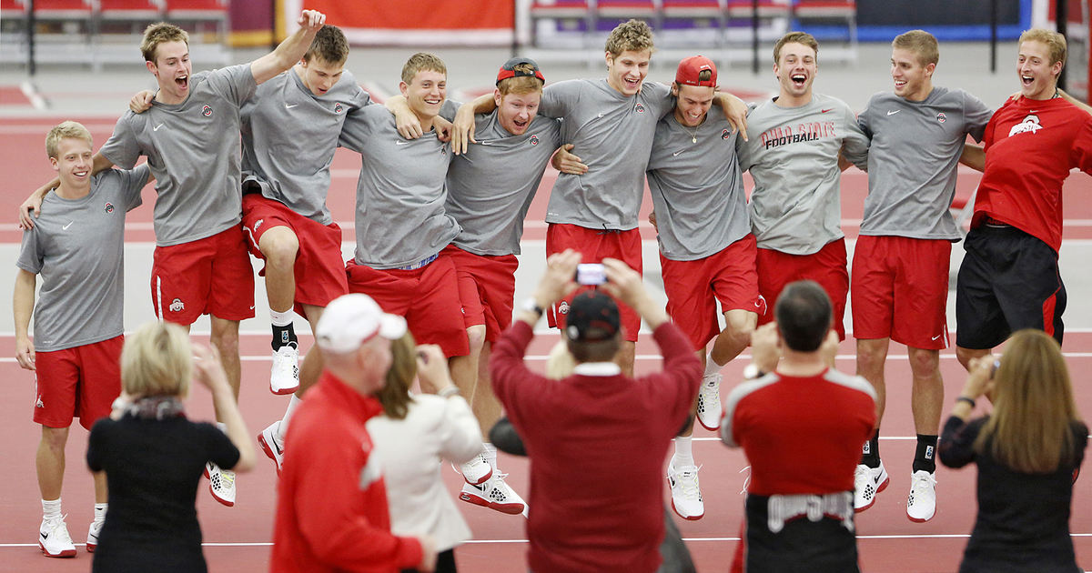Award of Excellence, Ron Kuntz Sports Photographer of the Year - Chris Russell / The Columbus Dispatch The Ohio State University tennis team poses for a victory photo taken by friends and family after their match home win over Wisconsin on April 5, 2013.  The win was the team's 164th home victory and is the longest active among all Division 1 sports.  