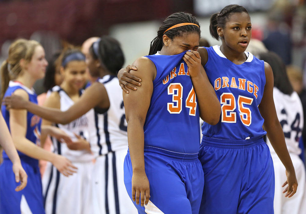 Award of Excellence, Ron Kuntz Sports Photographer of the Year - Chris Russell / The Columbus Dispatch Olentangy Orange's #34 Mya Walker is comforted by teammate Mikaela Lyons after their team's tournament loss to Twinsburg at Nationwide Arena on March 15, 2013.   