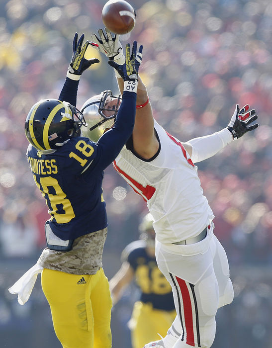 Award of Excellence, Ron Kuntz Sports Photographer of the Year - Chris Russell / The Columbus DispatchMichigan Wolverines defensive back Blake Countess (18) intercepts a pass meant for Ohio State Buckeyes tight end Nick Vannett (81) at Michigan Stadium in Ann Arbor, MI on November 30, 2013.  