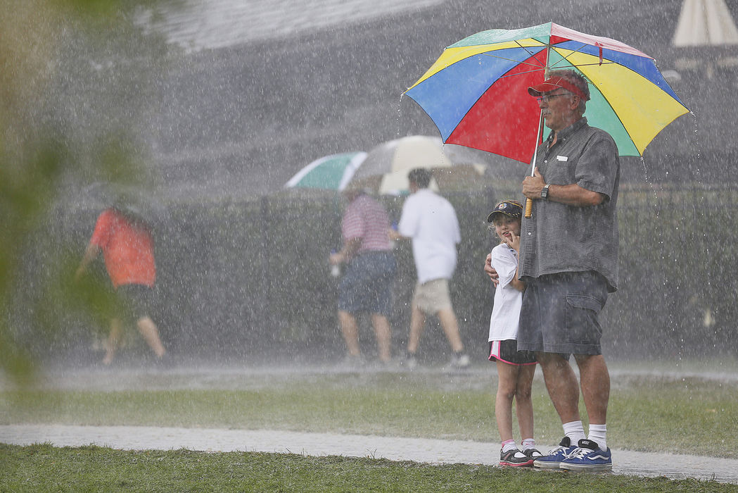 Award of Excellence, Ron Kuntz Sports Photographer of the Year - Chris Russell / The Columbus DispatchDave Kaiser and his granddaughter Olivia decided to stick it out  during a rainstorm delay in the third round of the Presidents Cup.