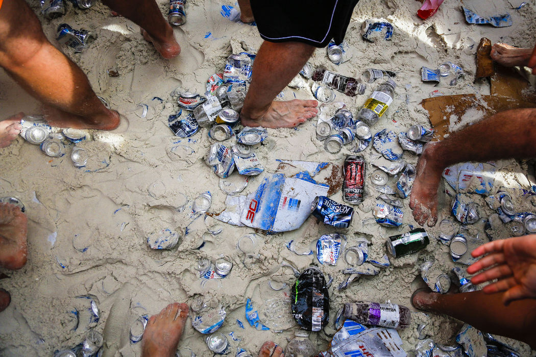First Place, Student Photographer of the Year - Jabin Botsford / Western Kentucky UniversitySpring breakers walk and dance on various beverage cans that have been left on the beach as students from around the country congregate to party and have a good time in Panama City Beach, Florida.
