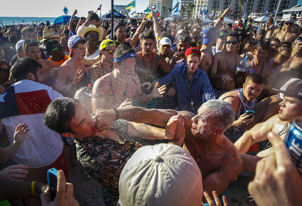 First Place, Student Photographer of the Year - Jabin Botsford / Western Kentucky UniversitySpring breakers fight on the beach in Panama City Beach, Fla. on Thursday March 14, 2013. During the spring break season of 2012, the average male reported drinking 18 drinks per day and the average female reported 10 drinks per day.  About half drank until they got sick or passed out at least once, according to the Journal of American College Health.