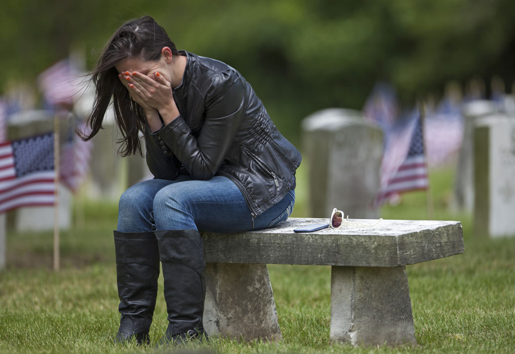 Second Place, Student Photographer of the Year - Alex Holt / University of KentuckyCarrie Tong, a 29 year old Army medic, sits alone on a stone bench in section 104 of Greenlawn Cemetery Monday afternoon, May 27, 2013. She hides her tears in her hands while she remembers those that she served with and was unable to save in Iraq.