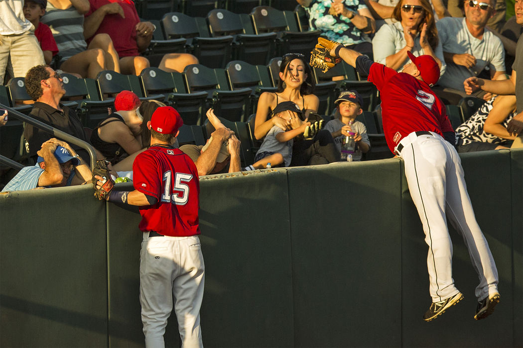 Second Place, Student Photographer of the Year - Alex Holt / University of KentuckyFans duck and cover their heads as Clippers shortstop Ryan Rohlinger leaps over the third base wall to reel in a foul ball Sunday evening, September 1, 2013.  