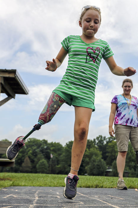 Second Place, Student Photographer of the Year - Alex Holt / University of KentuckyJulia Hurst, 10 from Newark, takes her turn at hopscotch Sunday afternoon, July 21, 2013. Julia was just biding her time until she get to the "gaga" pit. "Gaga" is a type of dodgeball played in a small circular walled in area. To get someone out you must hit them with the ball below the waist, but they can block and hit the ball with their hands. Camp Joy is working with the Amputee Coalition of America to bring children who have amputations or limb differences together and challenge them with fun events.  