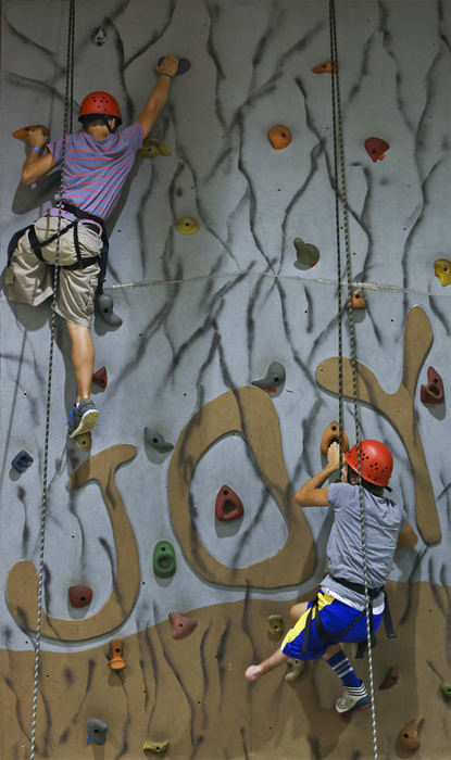 Second Place, Student Photographer of the Year - Alex Holt / University of Kentucky(Left) Josiah Puyear, 14 from Dallas, TX, heads to the top of the climbing wall while fellow camper (Right) Cody Kenyon, 14 from Toledo, OH, looks for his next handhold Monday afternoon, July 22, 2013. Campers at the Paddy Rossbach Youth Camp held at Camp Joy in Clarksville got to play volleyball, kickball, go canoeing and many other activities. 