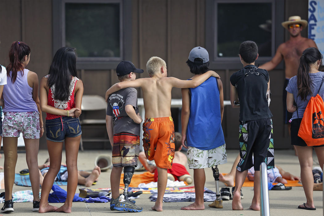 Second Place, Student Photographer of the Year - Alex Holt / University of KentuckyOne camper, who had already removed his prosthetic leg, is supported by two friends while they listen to a counselor go over the pool's rules Sunday afternoon, July 21, 2013. 