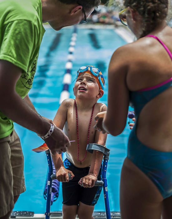 Third Place, Student Photographer of the Year - Logan Riely / Ohio UniversityThomas Prechtel, 5, receives a participation ribbon after swimming the 25 meter freestyle during the Southern Indiana Swim Association meet at South Harrison State Park in Elizabeth, Ind., on Saturday, July 13, 2013. He is diagnosed with Spina Bifida, which renders him unable to use his legs. This is his first summer swimming and is  apart of the Jeffersonville Aquatic swim team. His mother said that "it makes him feel free when he is floating the water."